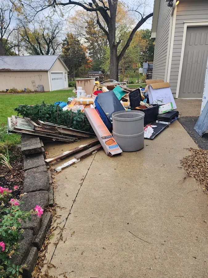 Dumpster being loaded with debris for Estate Cleanout Dumpster Rental in Largo